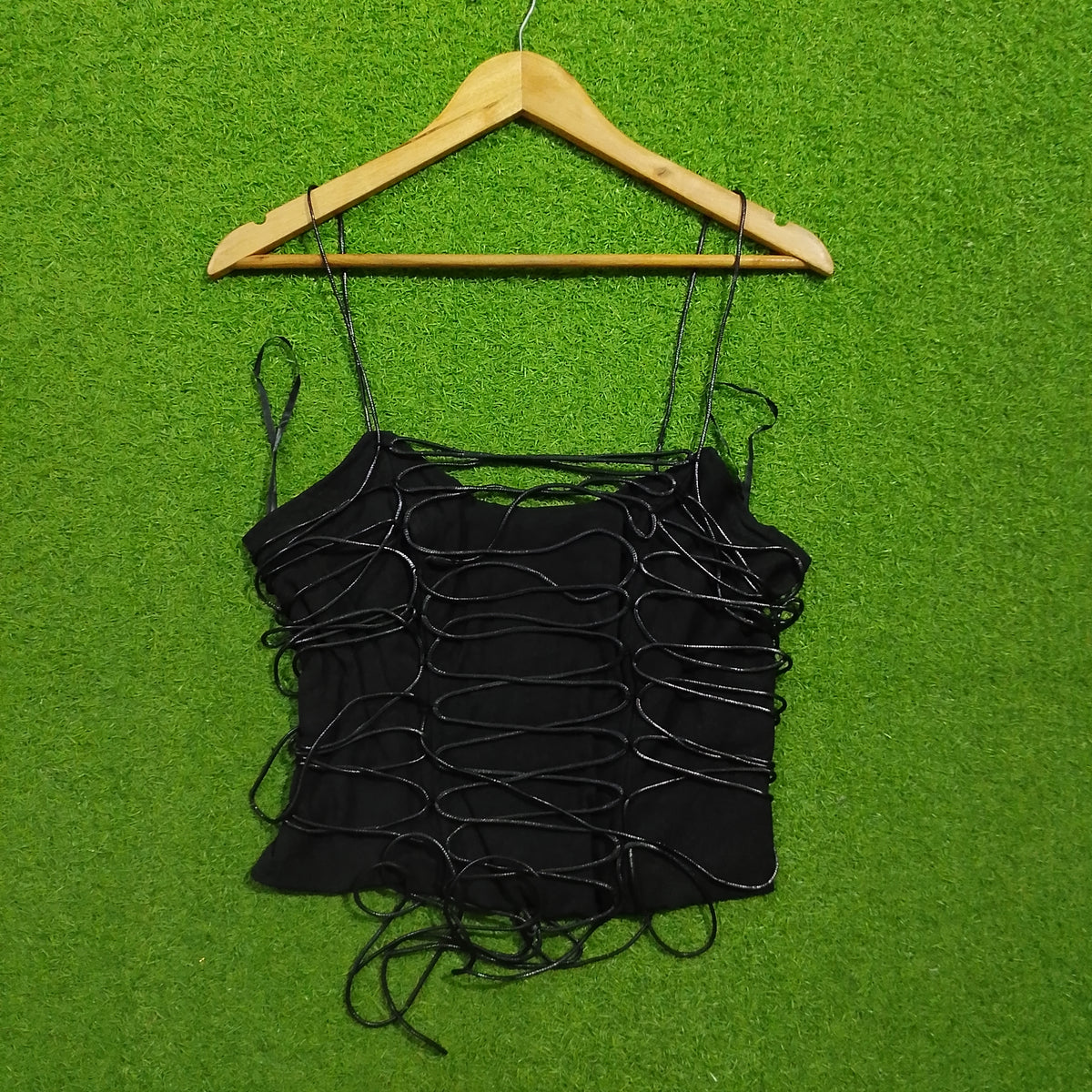 Black string loop detail spaghetti strap crop top - front view on hanger