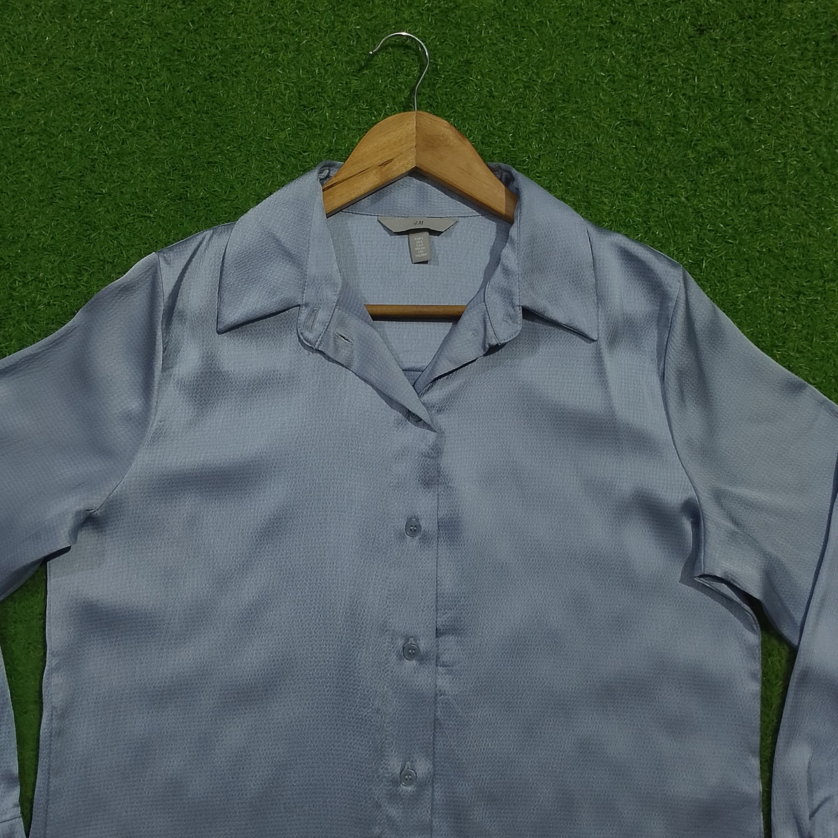 Light blue silk texture long sleeve shirt collar close-up