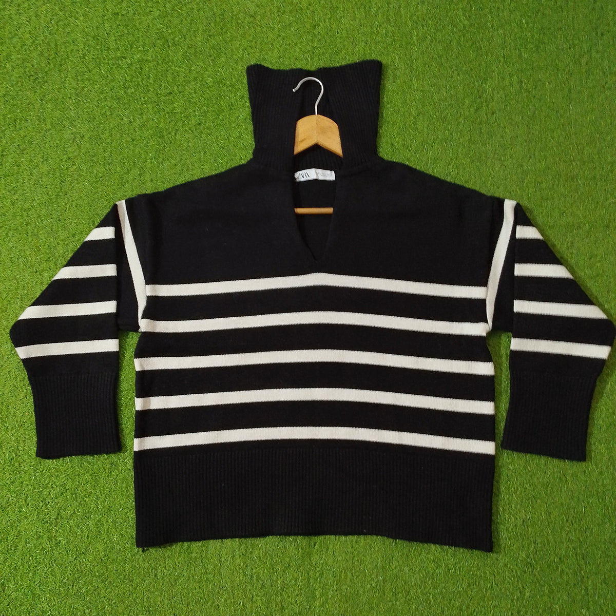 Black and white striped drop shoulder high ribbed collar open V-neck knit blouse - front view
