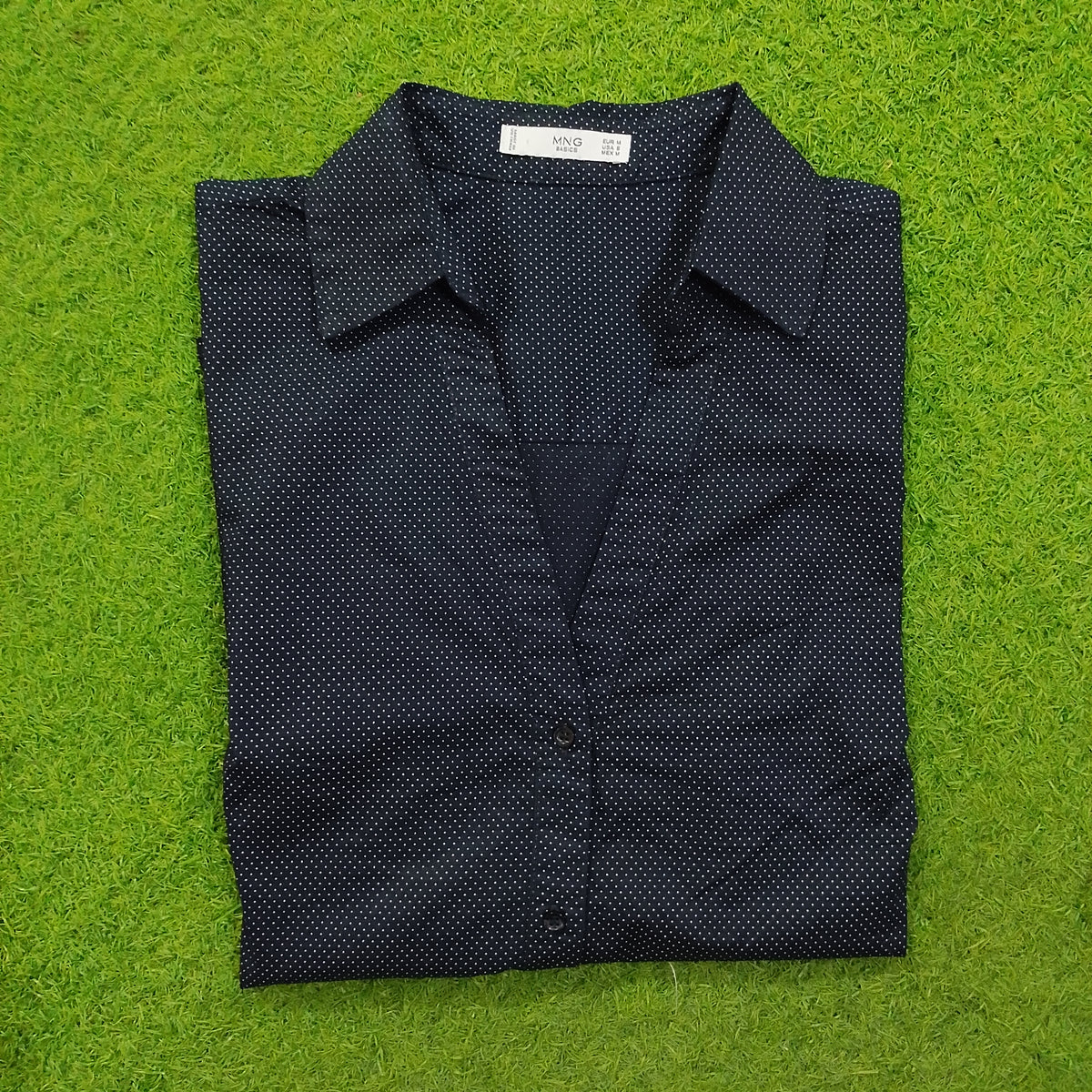 Navy blue polka dot cotton shirt by Mango - folded view