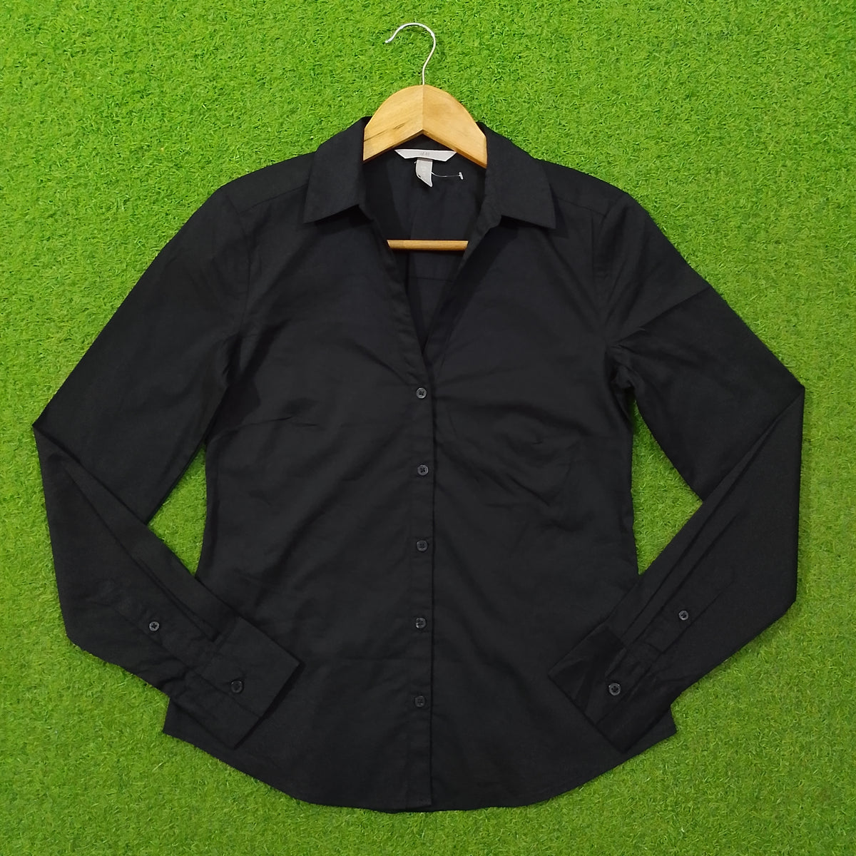 Black button-down cotton shirt by H&M - front view on hanger