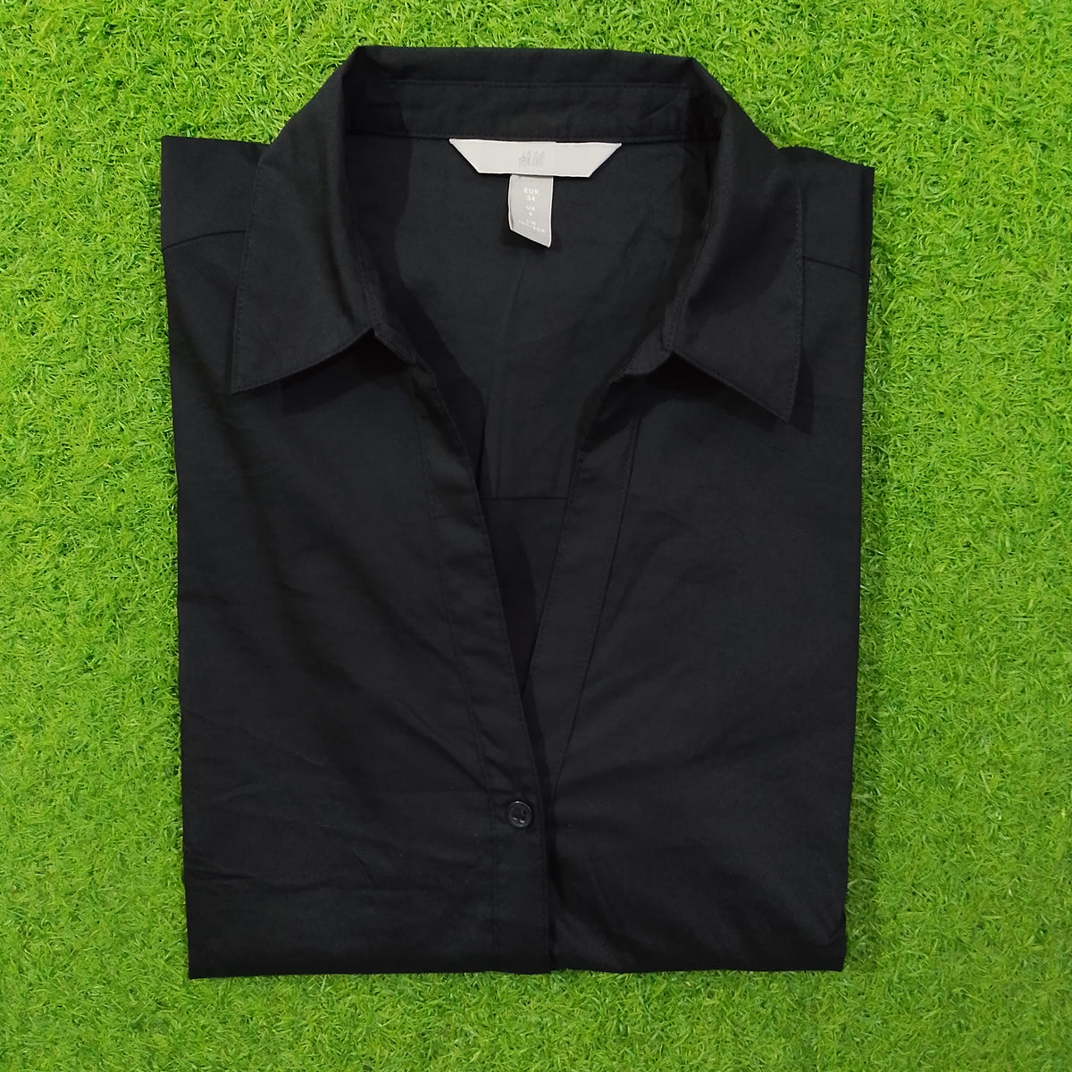 Black button-down cotton shirt by H&M - folded view