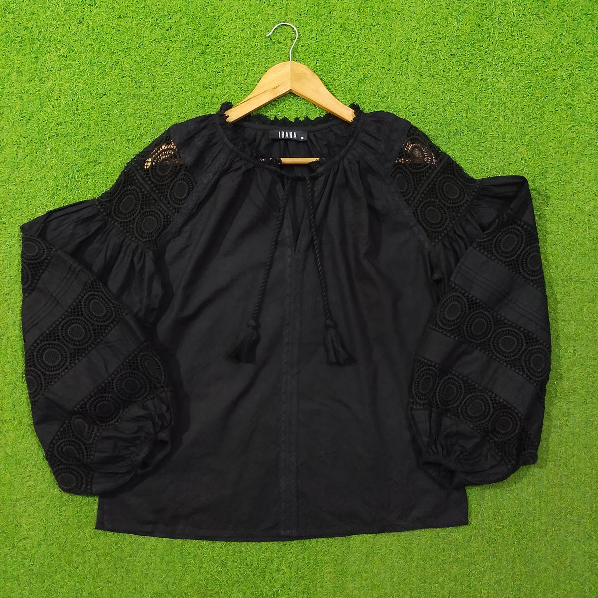 Black crochet lace puff sleeve cotton top by Ibana - full front view on hanger
