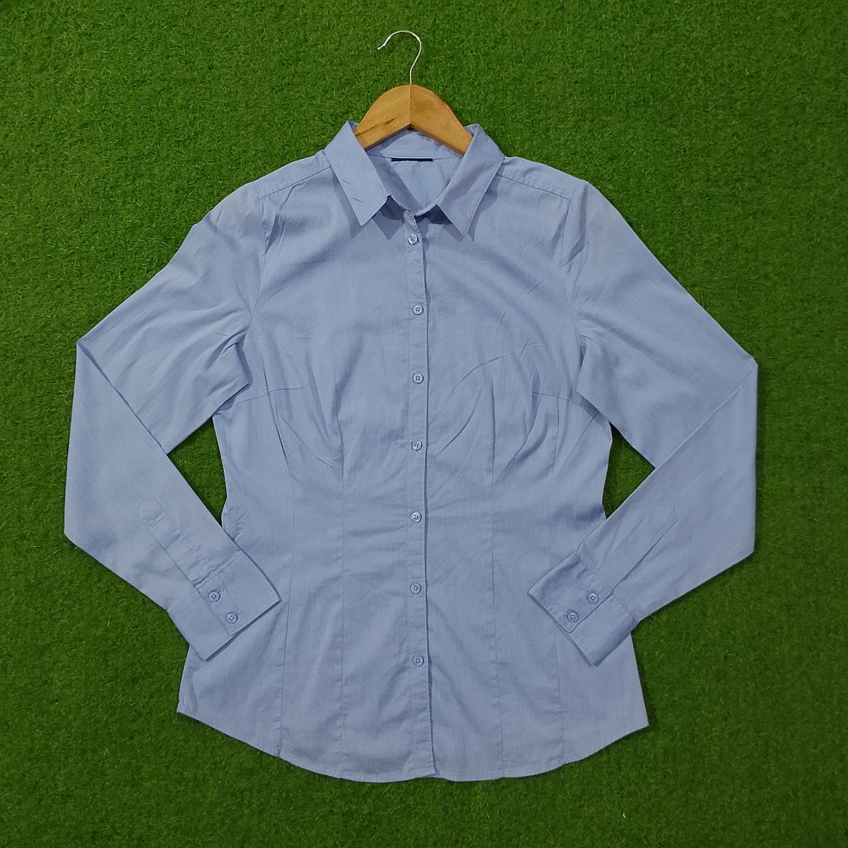 Light blue button-down cotton shirt - front view on hanger