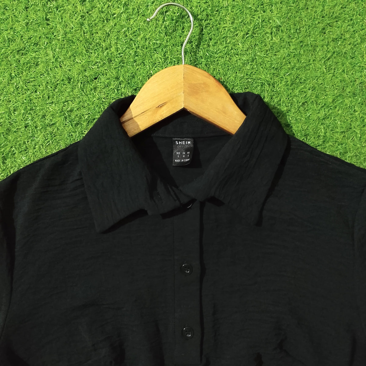 Black chiffon crush crop top Shein label close-up