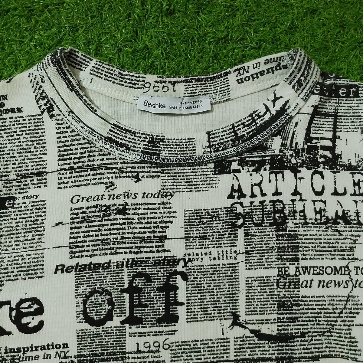 Newspaper print crop top Beishka label close-up