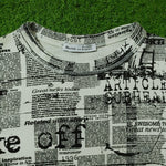 Newspaper print crop top Beishka label close-up