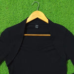 Shein label close-up on black ribbed knit shrug top