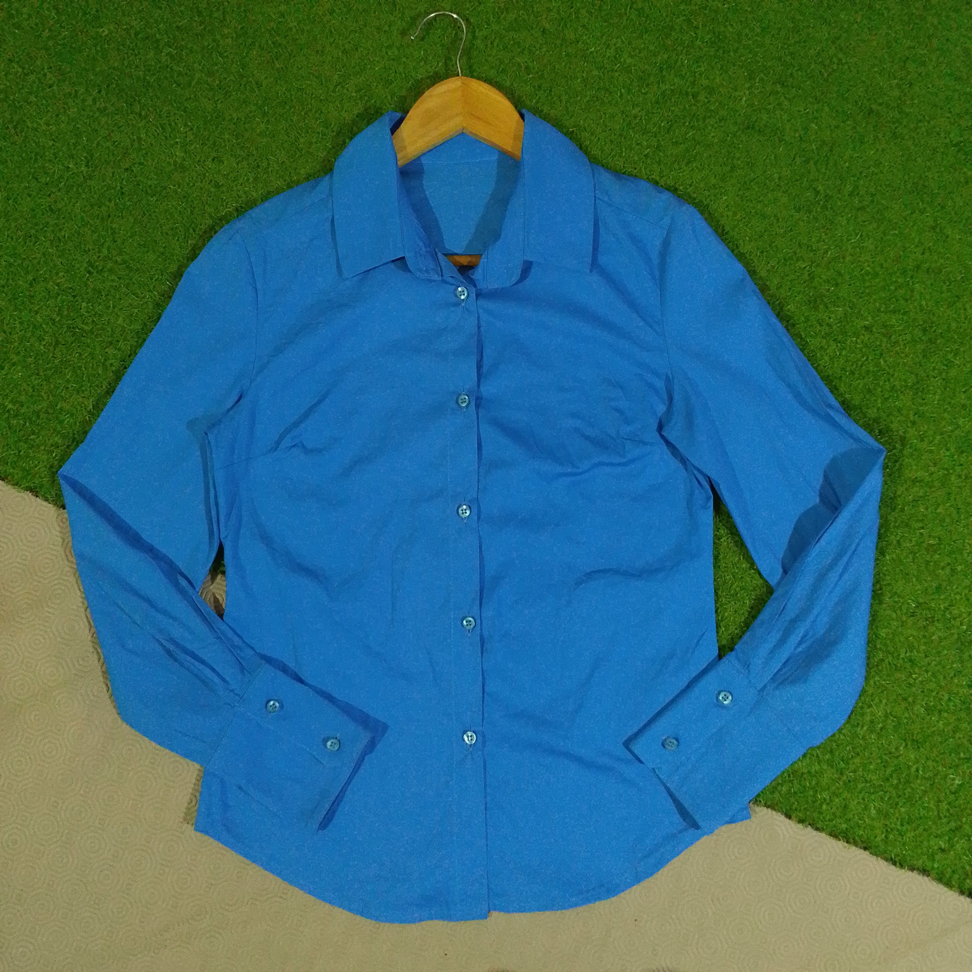 Blue women's button-down shirt front view