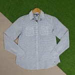 White shirt with black floral print, double chest pockets and buttoned cuffs on a wooden hanger