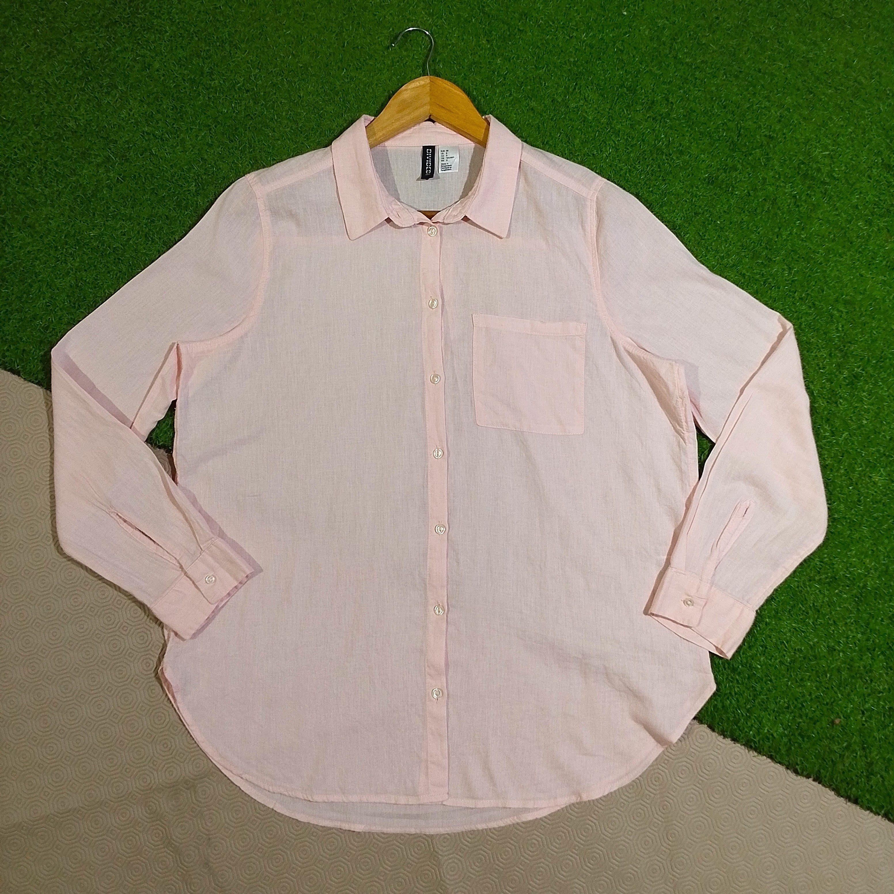 Light pink long sleeve button-front shirt with collar and chest pocket