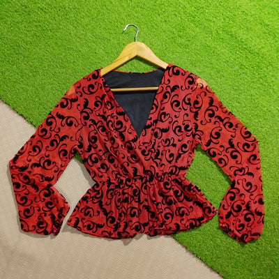 Red black printed peplum long sleeve top front view