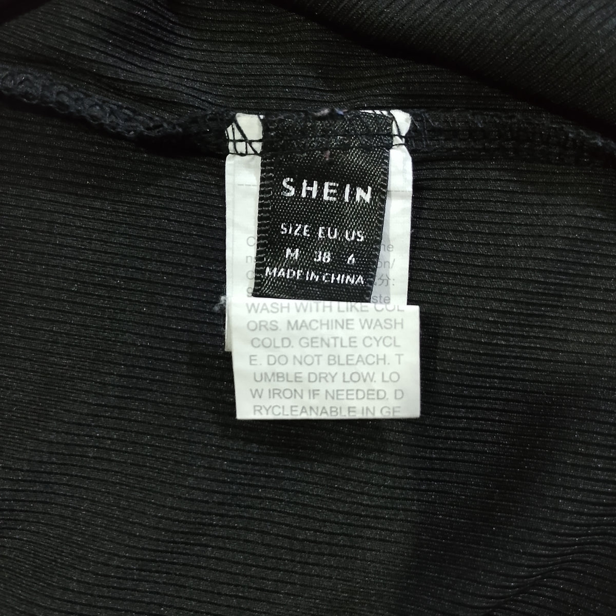 Black Shein crop top brand and size label