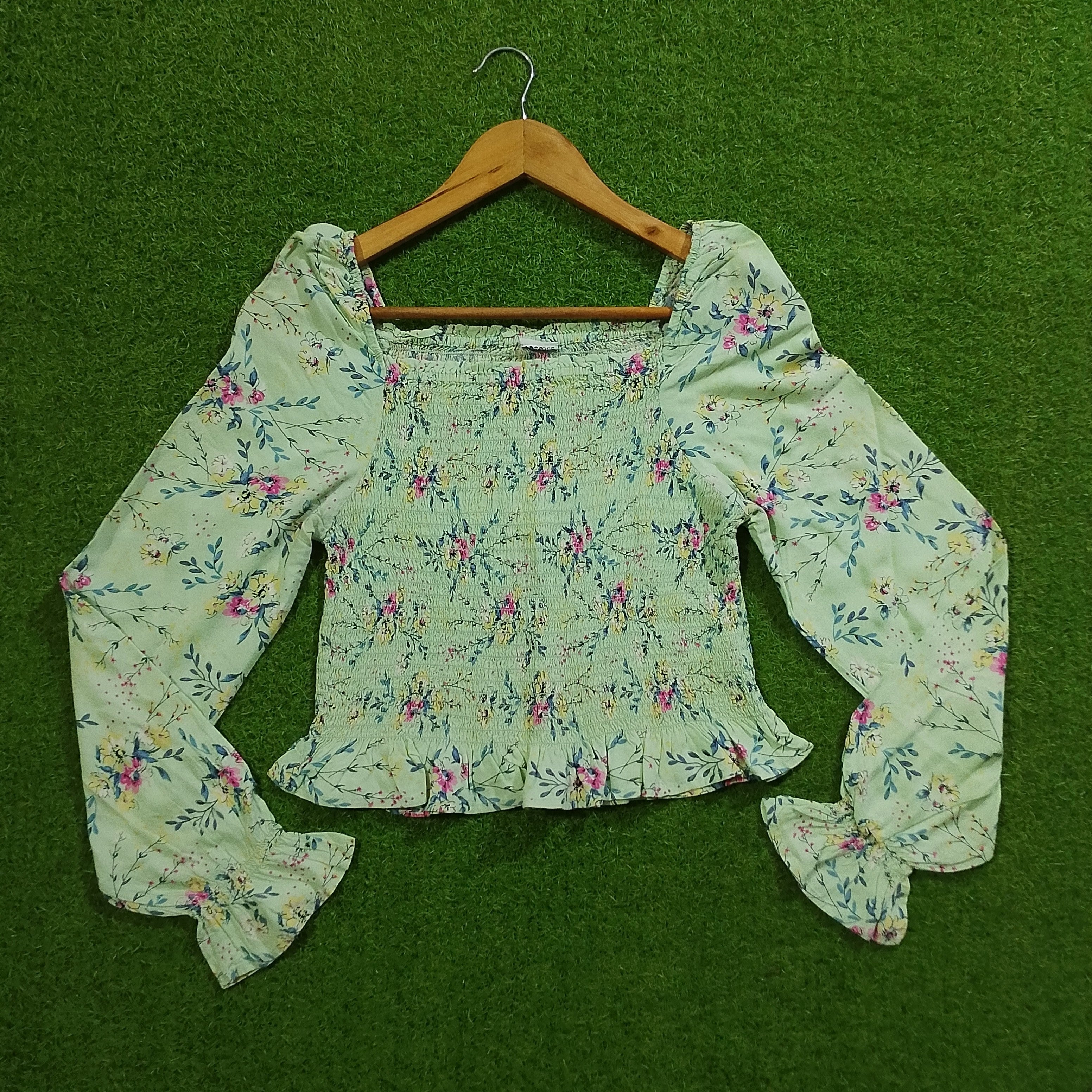 Sage green floral smocked puff sleeve crop top front view