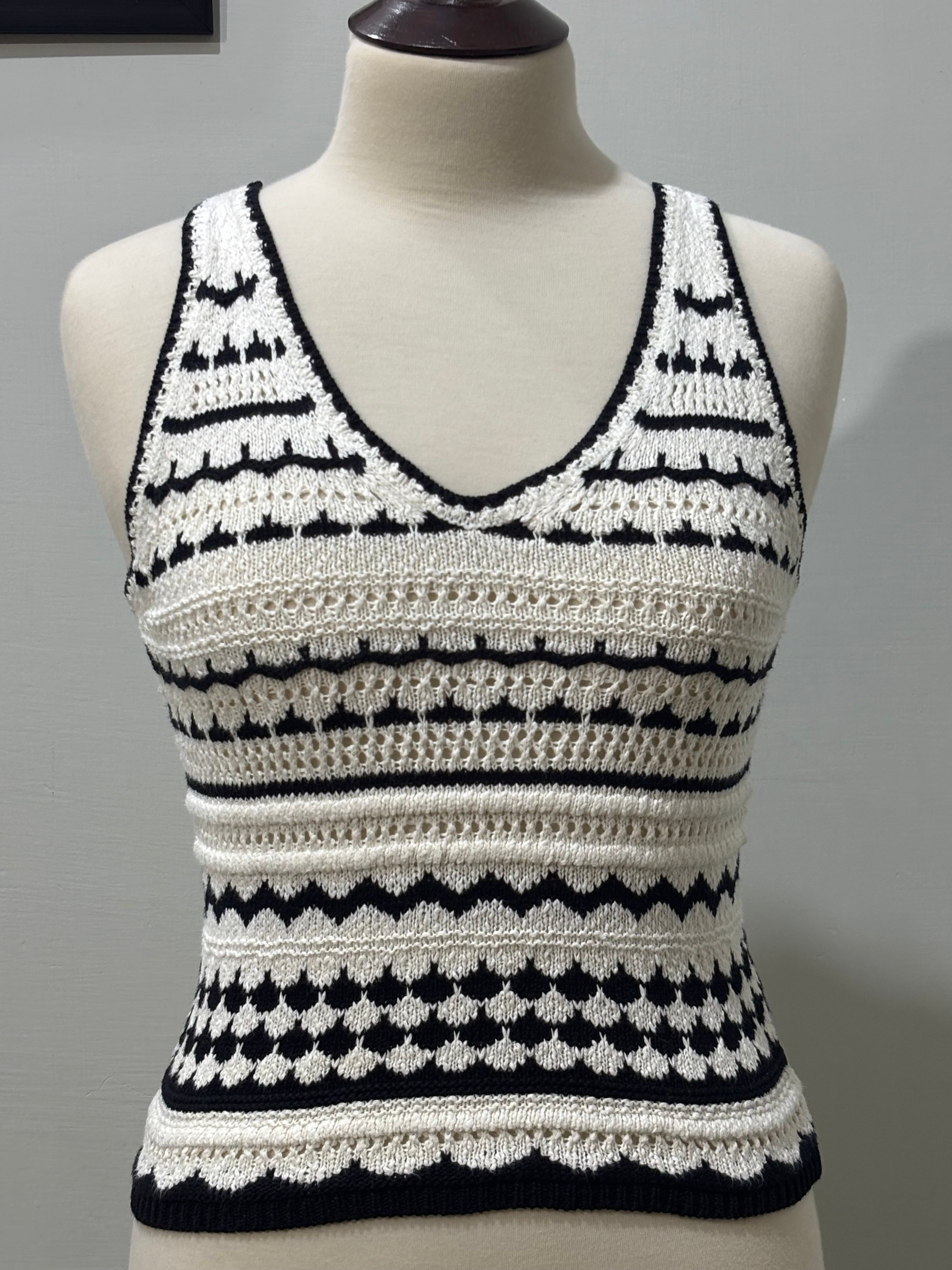 Front of black and white striped openwork sleeveless V-neck top