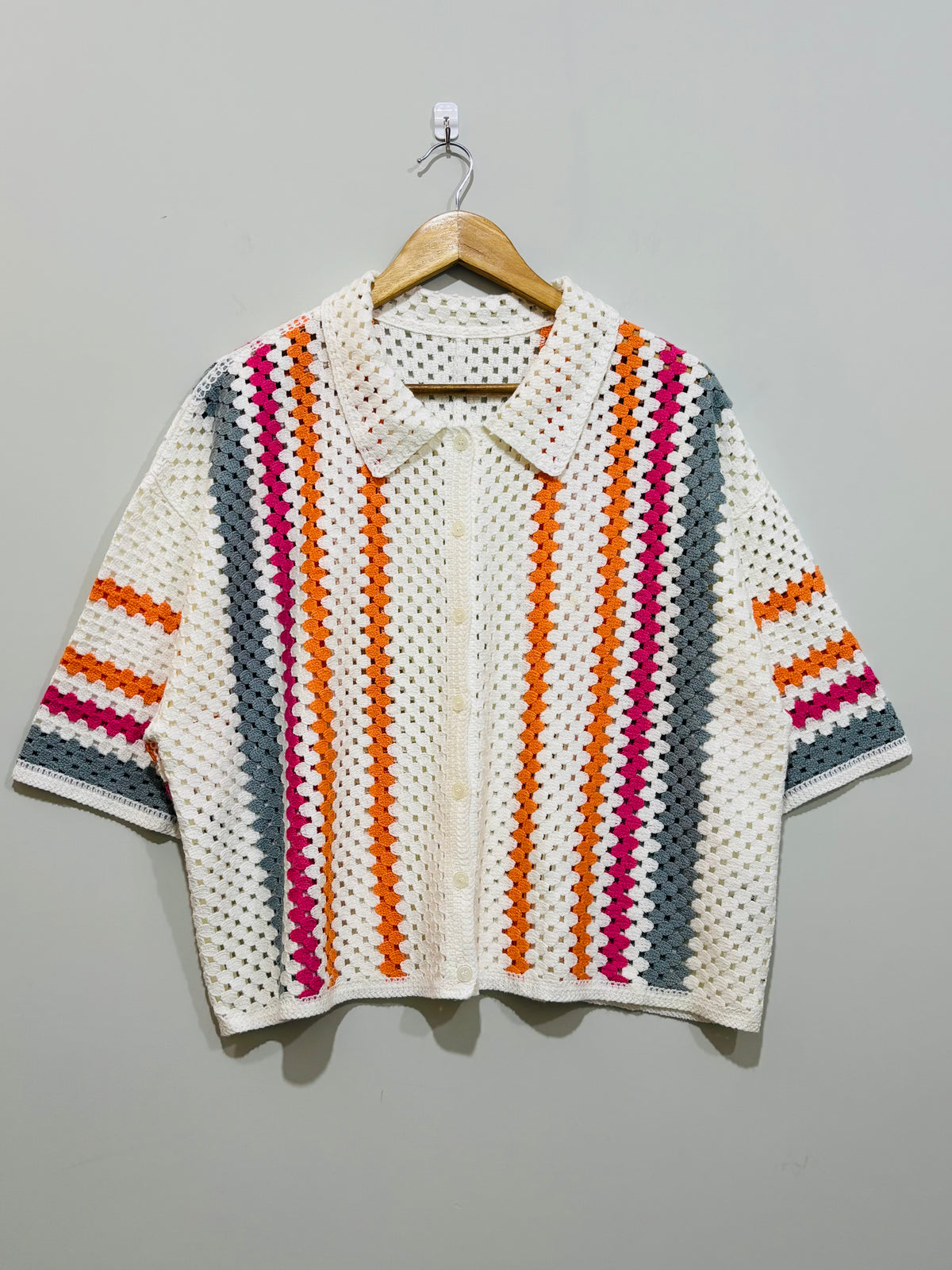 White crochet collared button-front shirt with orange pink and grey stripes and wide short sleeves