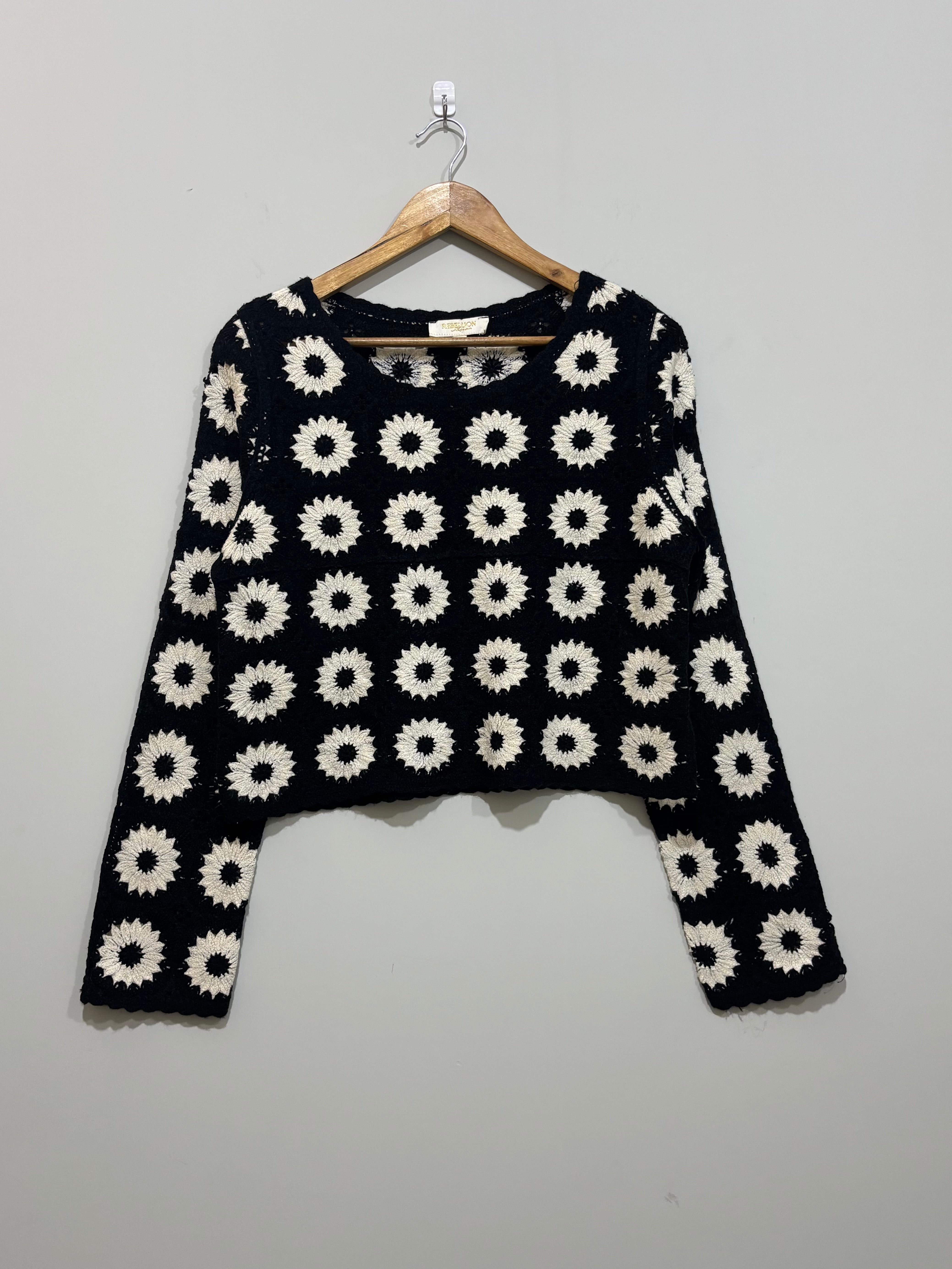 Black and white floral crochet long-sleeve crop top with round neckline