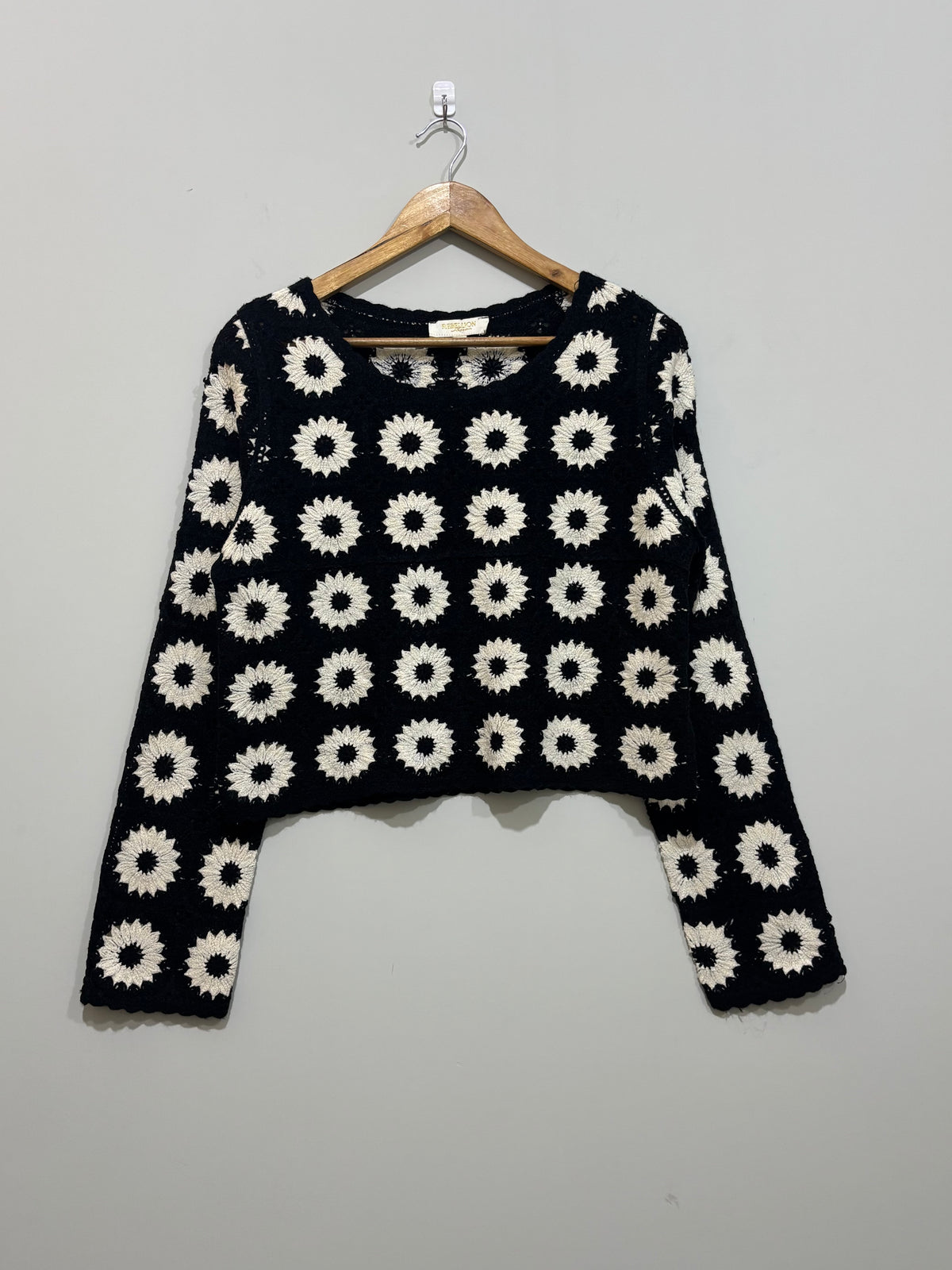Black and white floral crochet long-sleeve crop top with round neckline