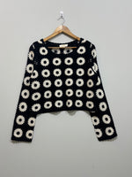 Black and white floral crochet long-sleeve crop top with round neckline