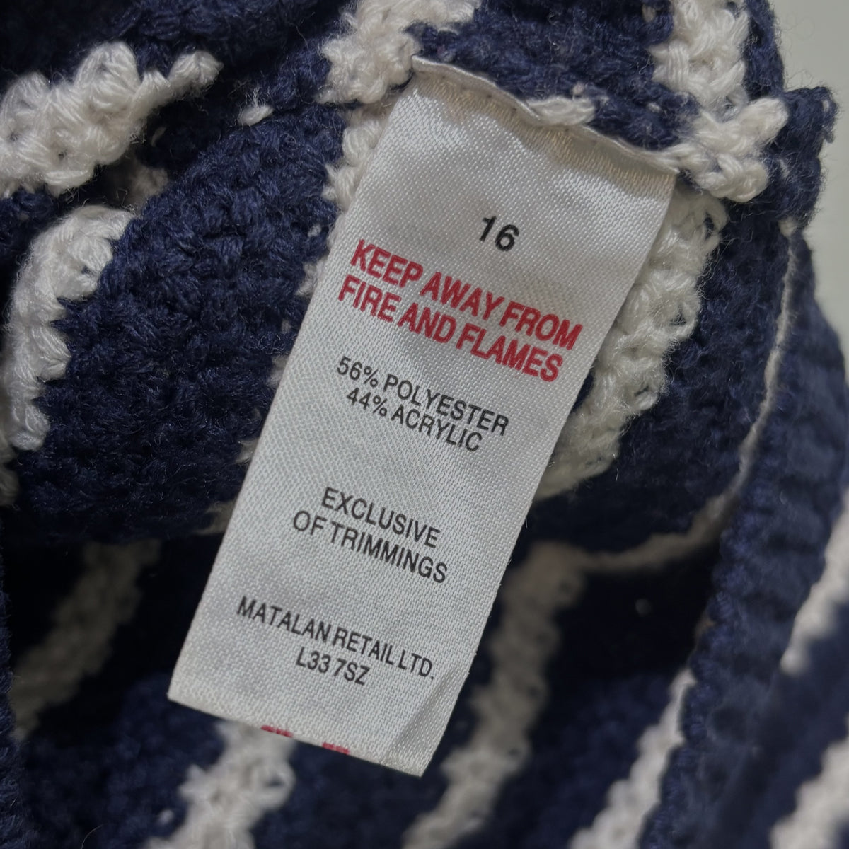 Cardigan label showing size 16 and fabric composition of 56% polyester and 44% acrylic.