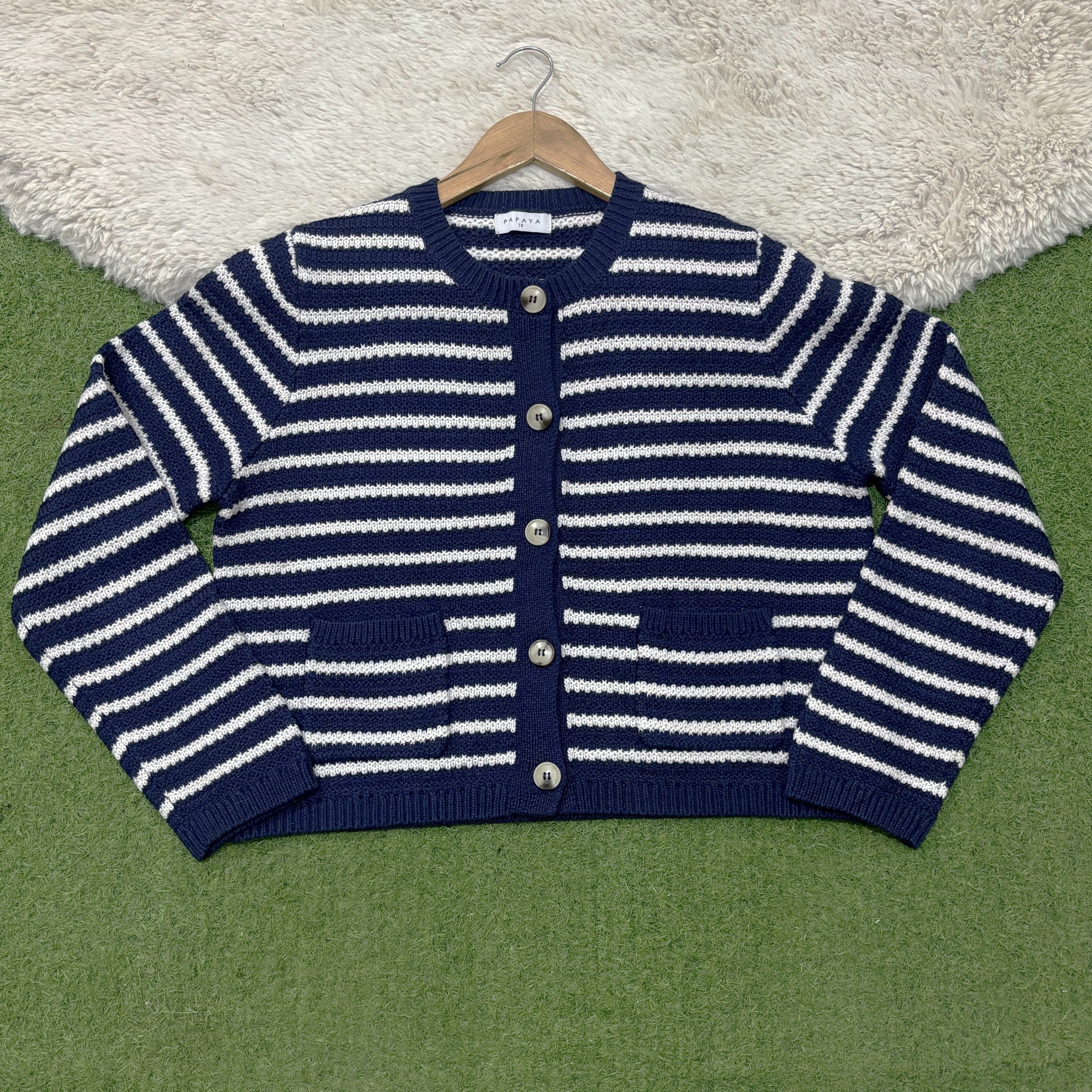 Navy and white horizontally striped round-neck cardigan with five contrast buttons, two patch pockets, long sleeves and navy ribbed trims.