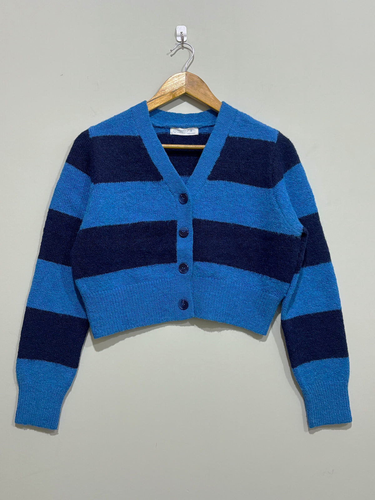 Blue and navy wide-striped cropped cardigan with a V-neck, four front buttons, long sleeves and ribbed cuffs and hem.