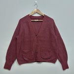 Burgundy textured V-neck cardigan with raglan sleeves, three front buttons, two patch pockets and ribbed cuffs and hem.
