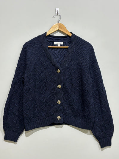 Navy cable-knit V-neck cardigan with four contrasting buttons, long raglan sleeves and ribbed cuffs and hem.