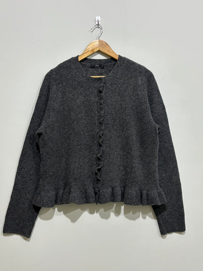 Charcoal grey round-neck cardigan with long sleeves, a ruffled button-front placket and ruffle hem.