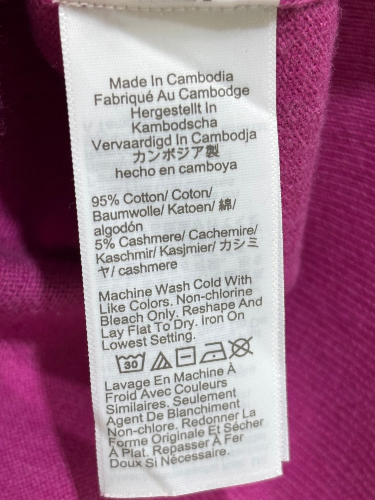 Fabric care label stating 95% cotton and 5% cashmere, made in Cambodia.