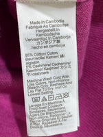 Fabric care label stating 95% cotton and 5% cashmere, made in Cambodia.