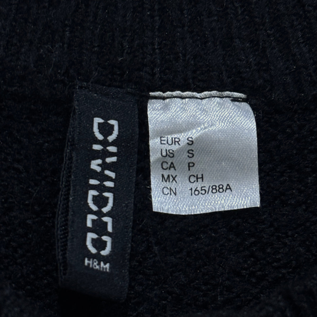 H&M Divided garment label showing EUR S and US S.