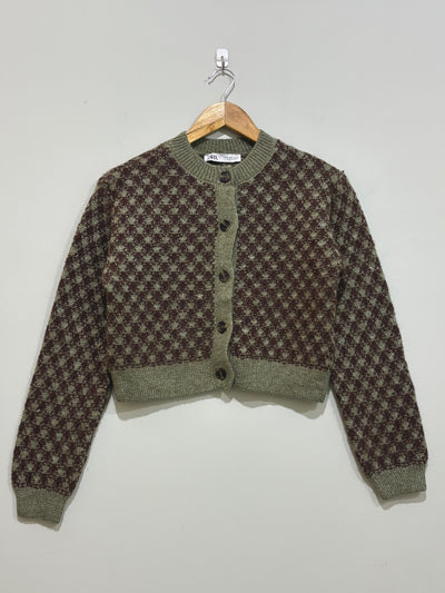 Olive green and brown geometric patterned cropped cardigan with a round neckline, front buttons and ribbed trims.