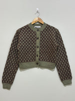 Olive green and brown geometric patterned cropped cardigan with a round neckline, front buttons and ribbed trims.