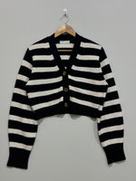Black and white horizontally striped cropped cardigan with a V-neck, three front buttons, long sleeves and ribbed cuffs and hem.
