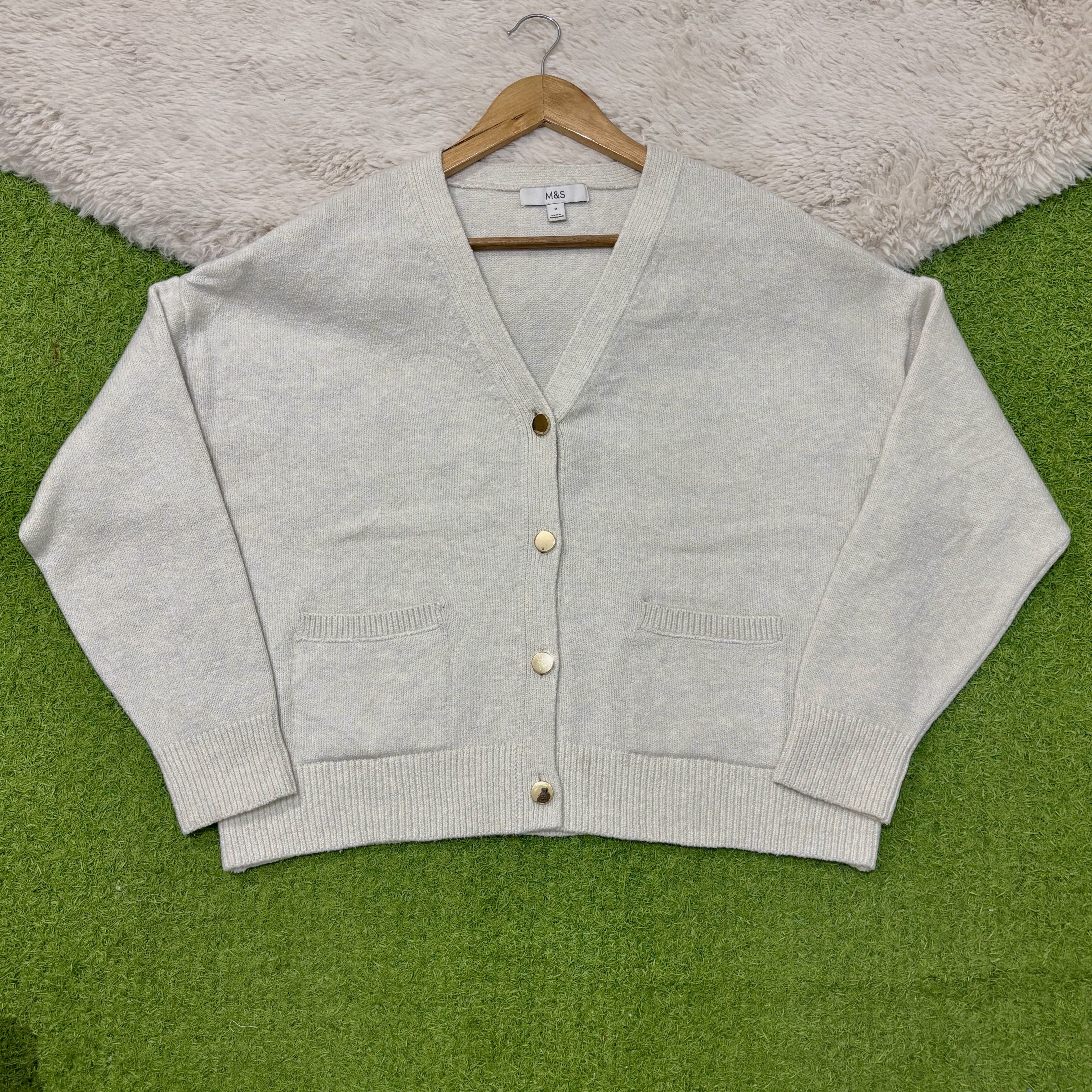 Light natural V-neck cardigan with dropped shoulders, four gold-tone buttons, two patch pockets and ribbed cuffs and hem.