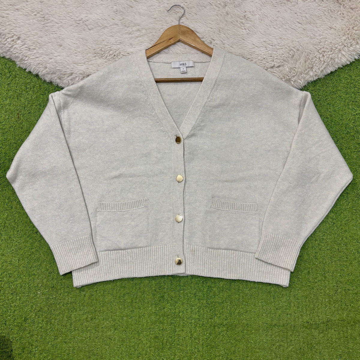Light natural V-neck cardigan with dropped shoulders, four gold-tone buttons, two patch pockets and ribbed cuffs and hem.