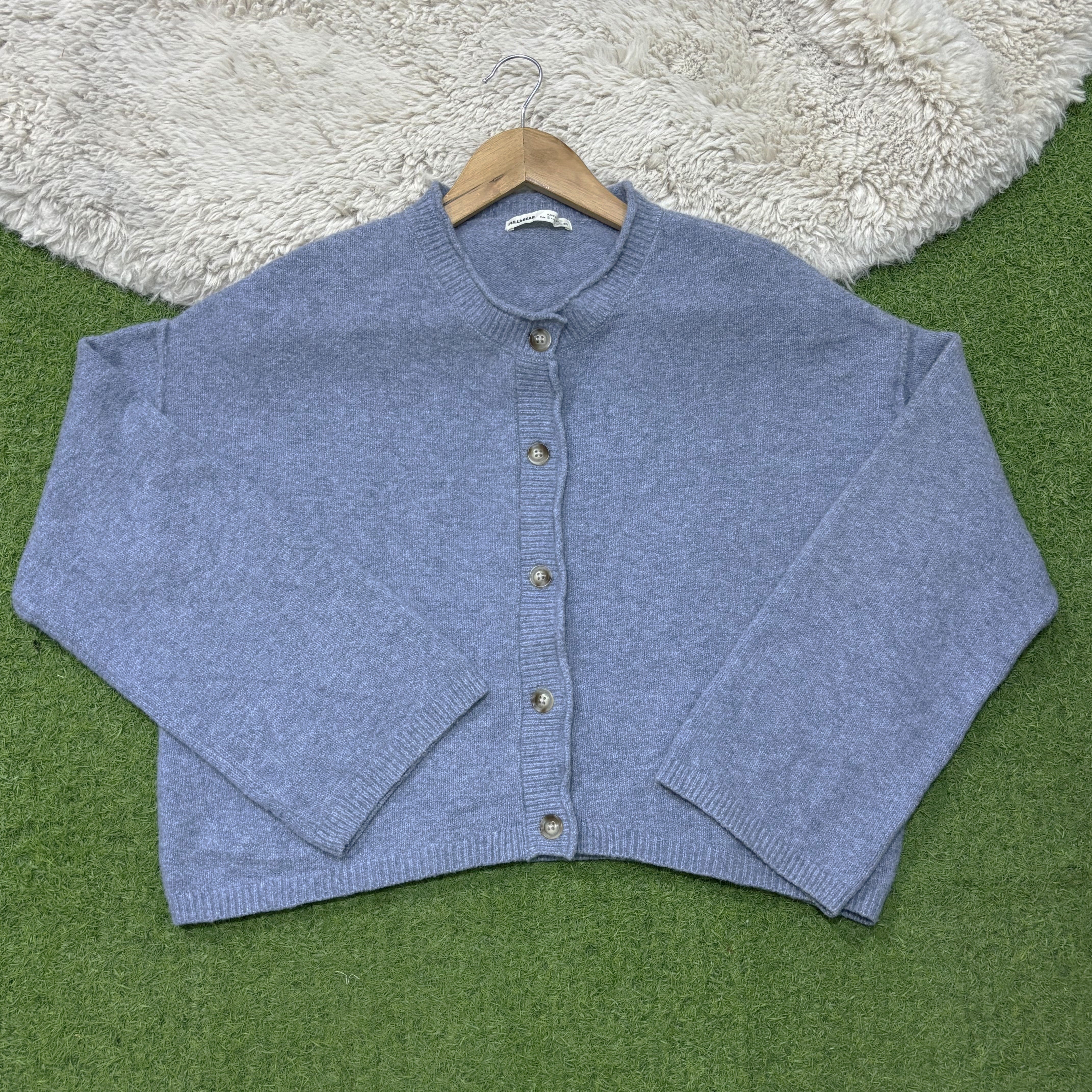 Dusty blue drop-shoulder cardigan with a round neckline, five front buttons, long sleeves and ribbed cuffs and hem.