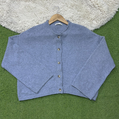Dusty blue drop-shoulder cardigan with a round neckline, five front buttons, long sleeves and ribbed cuffs and hem.