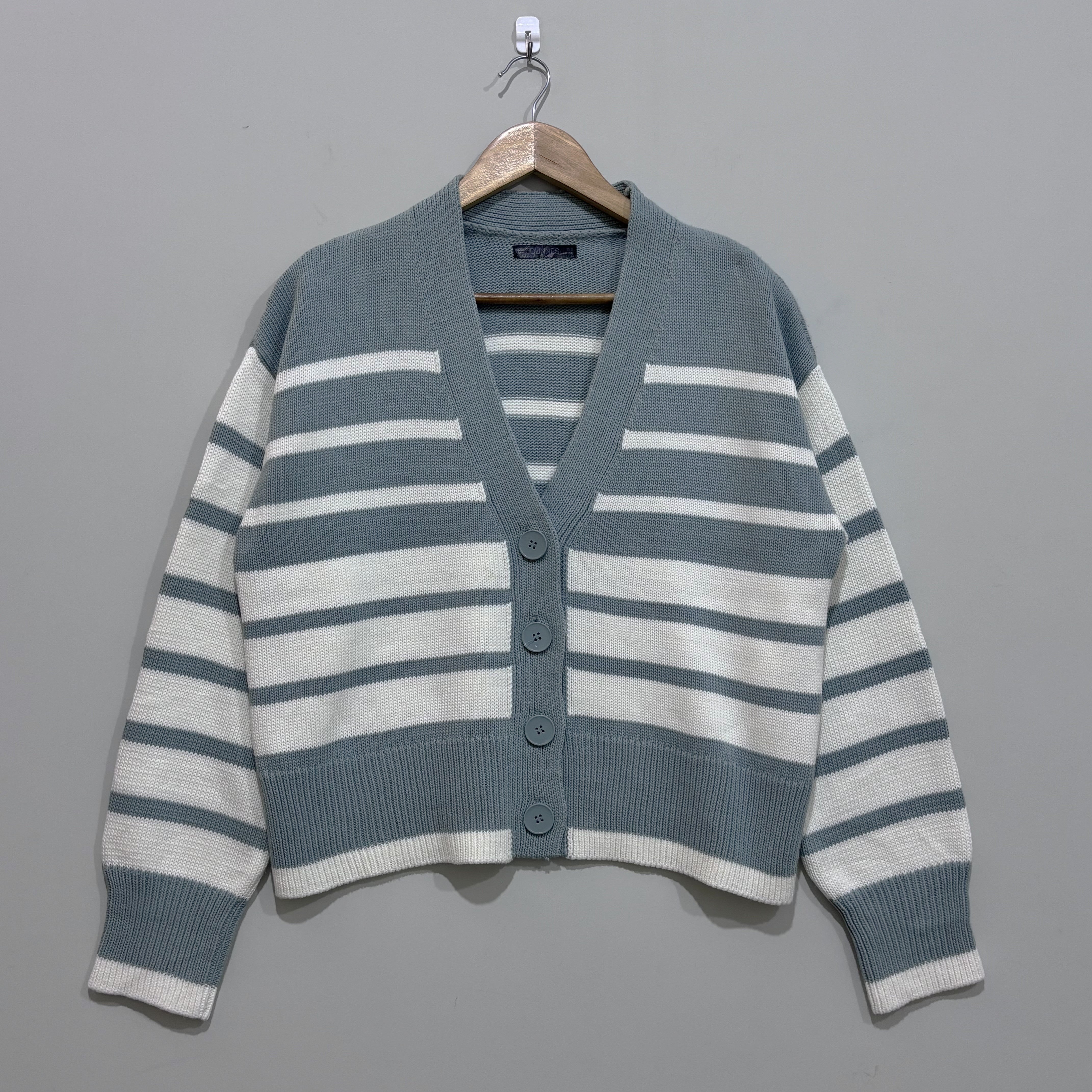 Sage green and white striped V-neck cardigan with dropped shoulders, four matching buttons, long sleeves and ribbed cuffs and hem.