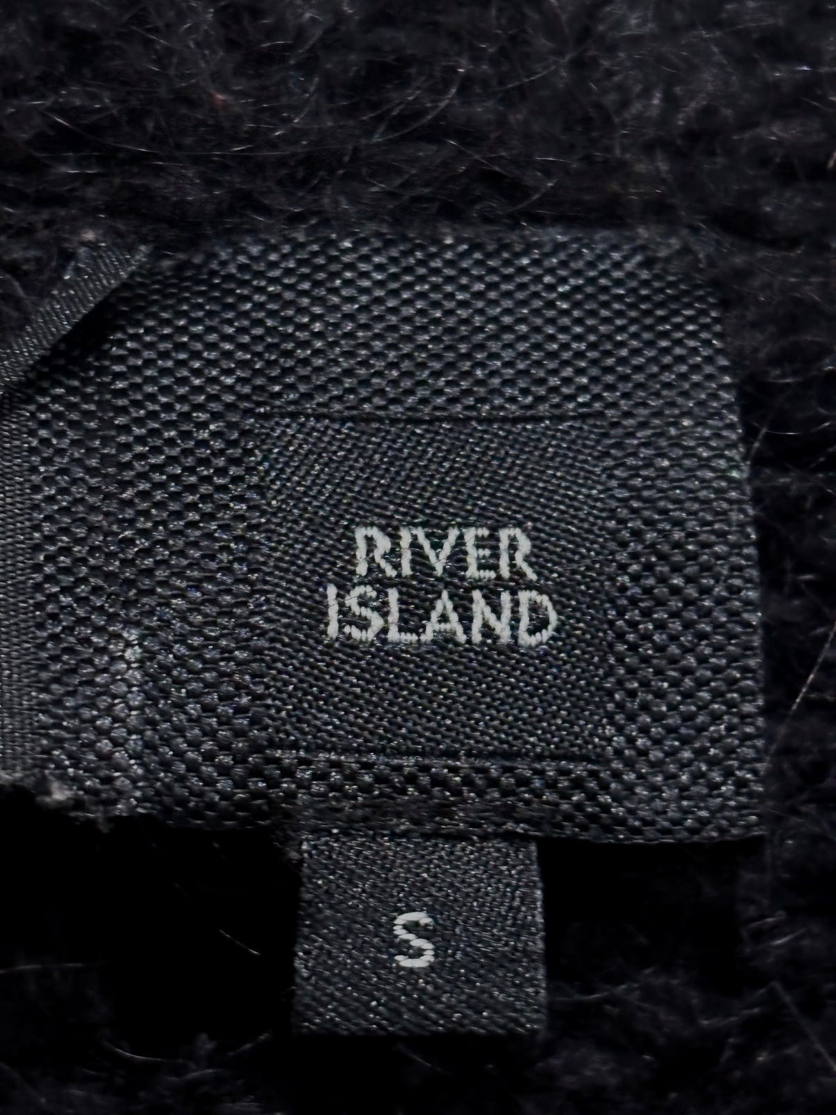 River Island clothing label with a separate size S tag.