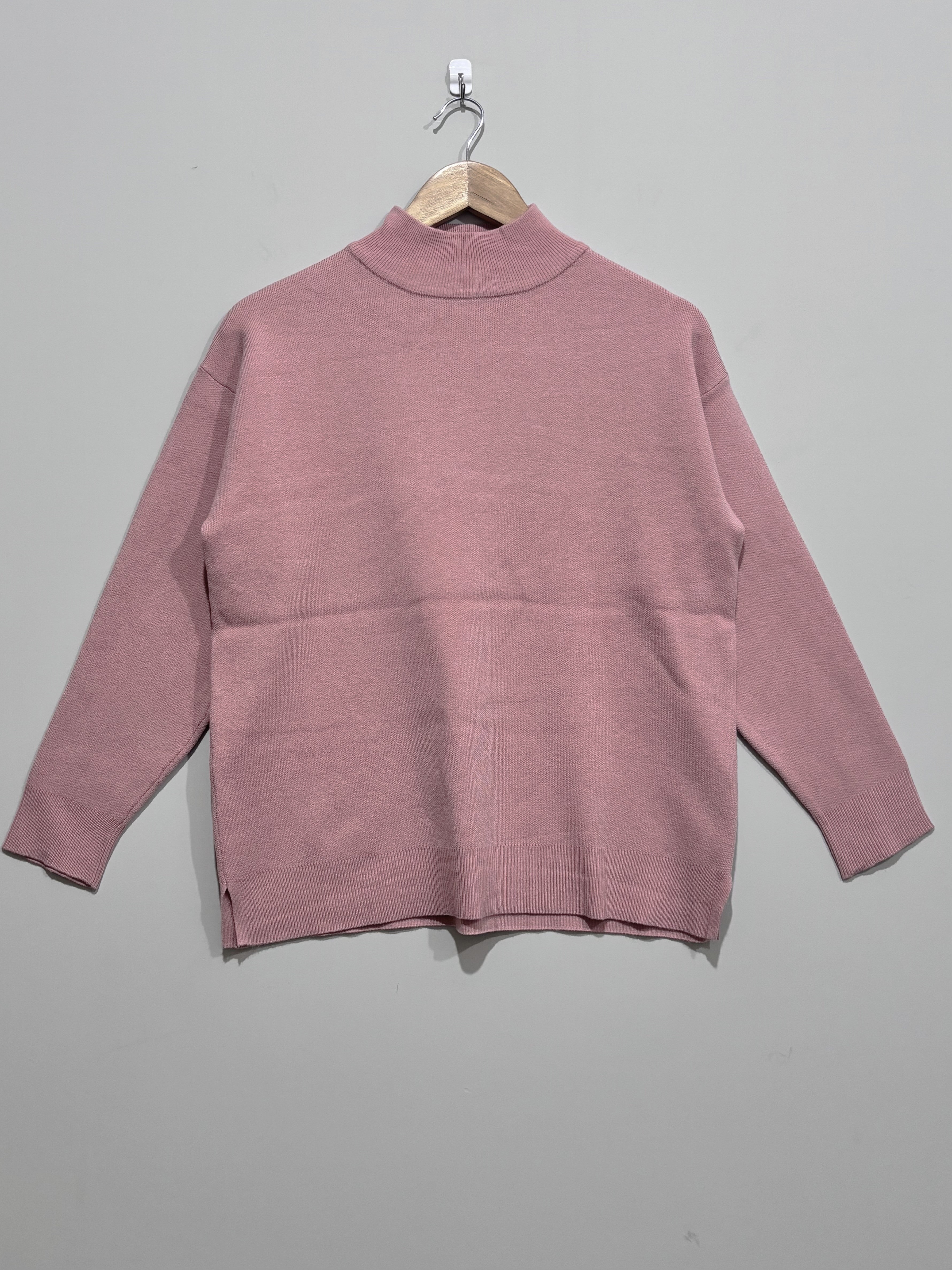 Dusty pink high-neck pullover with dropped shoulders, long sleeves, ribbed cuffs and hem, and side slits.