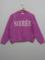 Pink crew-neck knitted blouse with sparkling Soirée lettering across the chest, long sleeves and ribbed cuffs and hem.