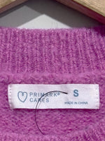 Primark Cares label showing size S on the pink knitted blouse.