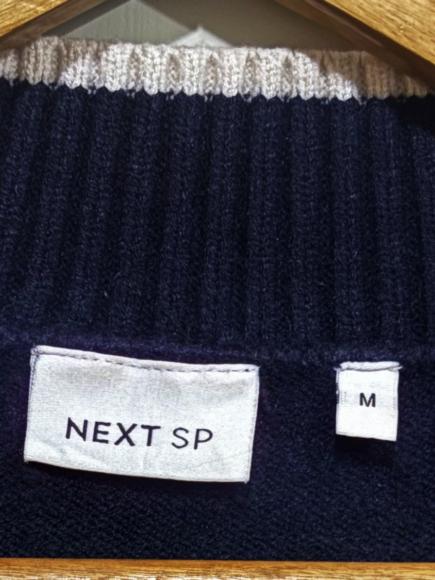 NEXT SP clothing label with a separate size M tag.