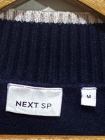 NEXT SP clothing label with a separate size M tag.