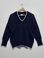 Navy blue V-neck pullover with light contrast edging along the neckline, cuffs and hem, long sleeves and deep ribbed trims.
