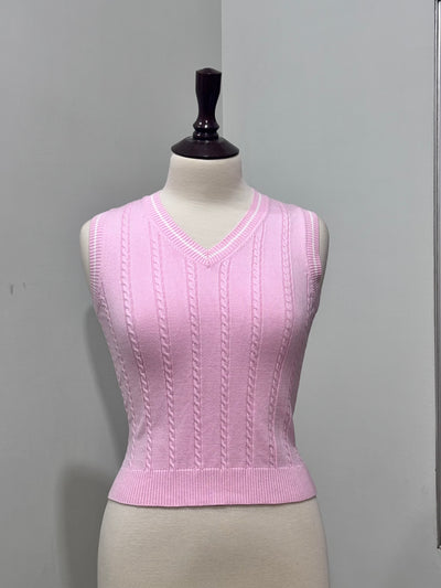 Pink cable-knit sleeveless V-neck sweater vest with ribbed hem on a mannequin