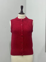 Red button-front knitted vest with ribbed edging on a mannequin
