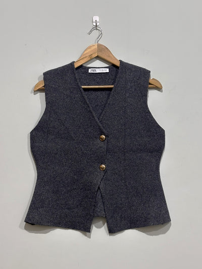 Charcoal grey V-neck sleeveless vest with two gold-tone buttons and shaped waist